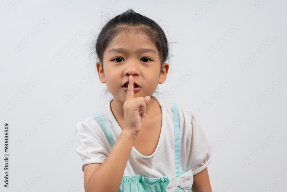 Portrait of happy and funny Asian child girl on white background, a child looking at camera. Preschool kid dreaming fill with energy feeling healthy and good concept Portrait of happy and funny Asian child girl on white background, a child looking at camera. Preschool kid dreaming fill with energy feeling healthy and good concept