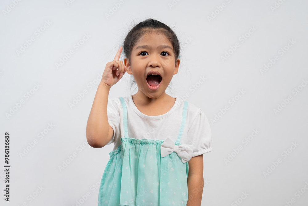 Portrait of Asian child 5 year old and to collect hair and Place her hands on her chin and make thinking pose on isolated white background, She is Happiness, radiance in youth, Education Concept Portrait of Asian child 5 year old and to collect hair and Place her hands on her chin and make thinking pose on isolated white background, She is Happiness, radiance in youth, Education Concept