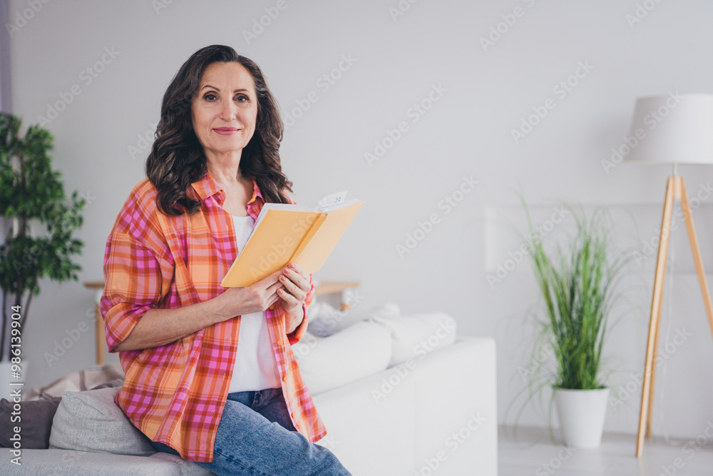 Photo of shiny cute woman dressed checkered shirt enjoying book indoors house apartment room