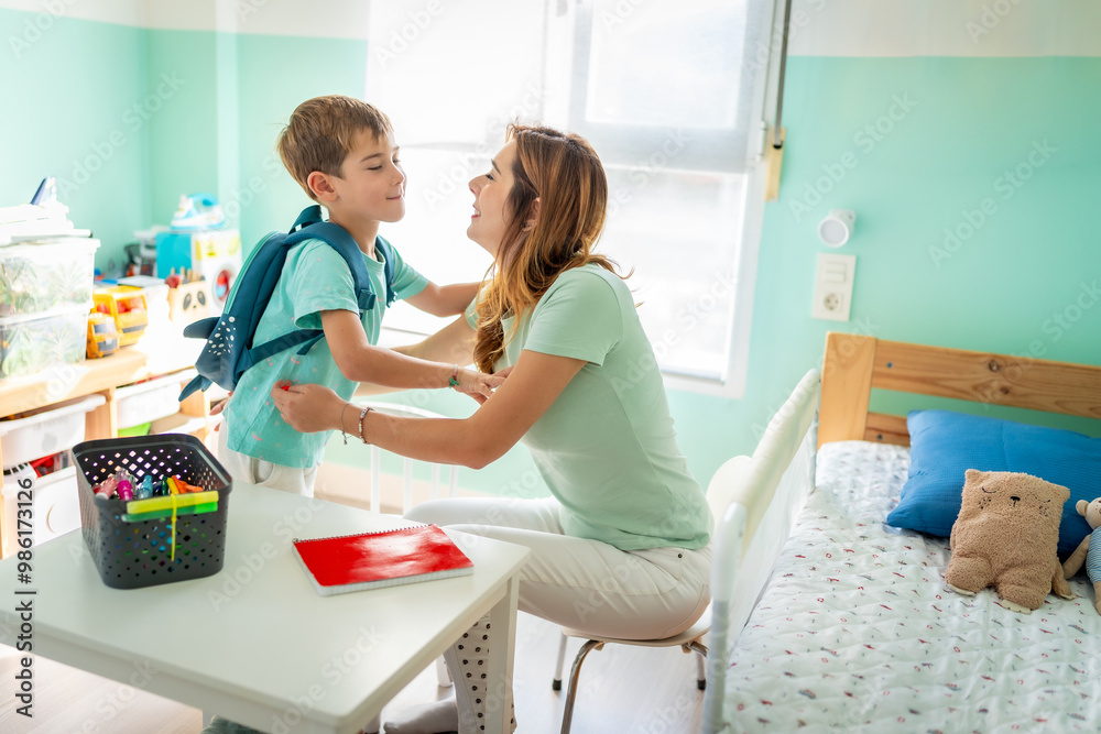 Mother kissing her son before going to school Mother kissing her son before going to school