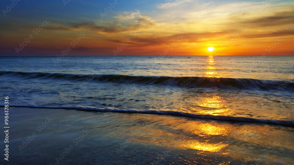 Fototapeta premium Blurred bokeh of a sunrise over a calm ocean