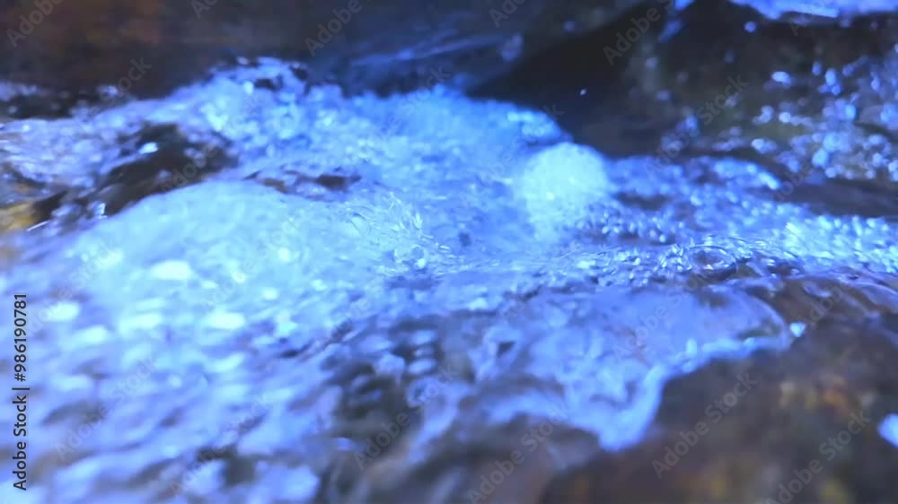 A video of water flowing down a rock, giving the illusion that it’s emerging from below, though it’s falling from above. The perspective adds a unique and intriguing effect to the natural scene. A video of water flowing down a rock, giving the illusion that it’s emerging from below, though it’s falling from above. The perspective adds a unique and intriguing effect to the natural scene.