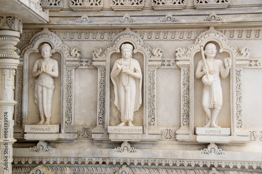 Obraz premium A white marble sculpture of a Hindu saint in the temple. Oldest temple in India. Beautiful sculpture of ancient India 13th century. Wall mounting background. Wall poster. 