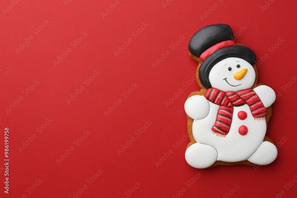 Tasty Christmas cookie in shape of snowman on red background, top view. Space for text Tasty Christmas cookie in shape of snowman on red background, top view. Space for text