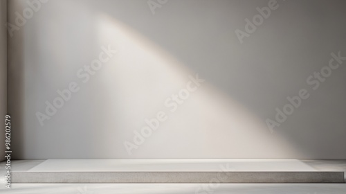 A wide, frameless mockup on a pale grey wall with soft spotlighting from above, casting a faint shadow along the bottom edge.