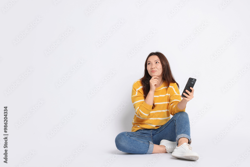 Young woman with smartphone on white background. Space for text Young woman with smartphone on white background. Space for text
