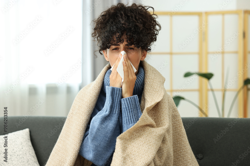 Cold symptom. Young woman with tissue at home Cold symptom. Young woman with tissue at home