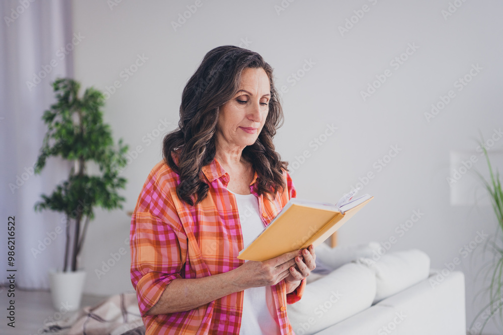 Photo of positive good mood woman dressed shirt enjoying book indoors house apartment room Photo of positive good mood woman dressed shirt enjoying book indoors house apartment room