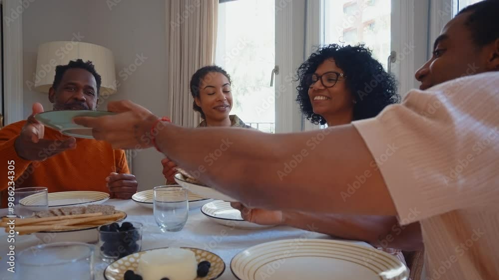 Cinematic video of a woman coming back home from the army military service in the us. Family reunited at lunch time indoor in a beautiful american house.