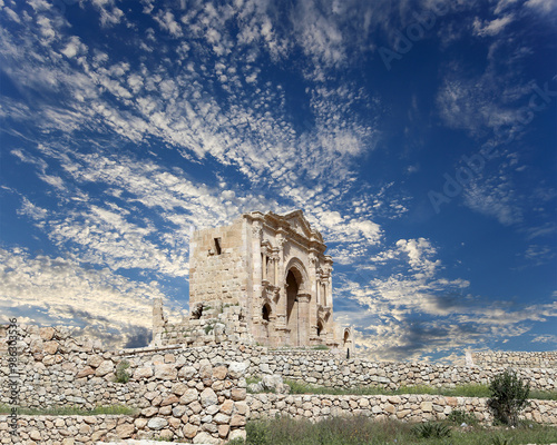 Arch of Hadrian in Gerasa (Jerash)-- was built to honor the visit of emperor Hadrian to Jerash in 129/130 AD, Jordan. Against the background of a beautiful sky with clouds #986303536