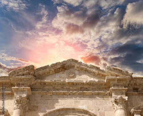 Arch of Hadrian in Gerasa (Jerash)-- was built to honor the visit of emperor Hadrian to Jerash in 129/130 AD, Jordan. Against the background of a beautiful sky with clouds #986303972