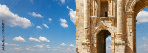 Arch of Hadrian in Gerasa (Jerash)-- was built to honor the visit of emperor Hadrian to Jerash in 129/130 AD, Jordan. Against the background of a beautiful sky with clouds #986304143