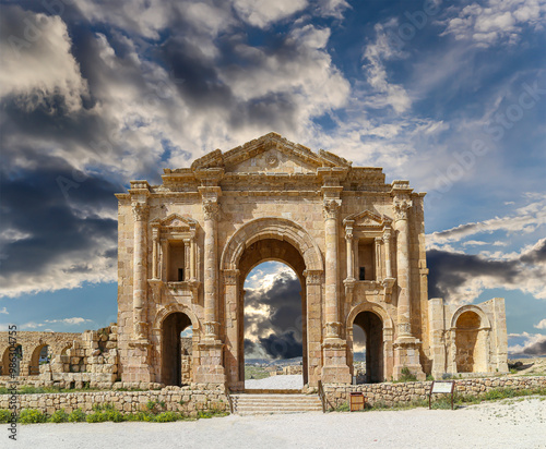 Arch of Hadrian in Gerasa (Jerash)-- was built to honor the visit of emperor Hadrian to Jerash in 129/130 AD, Jordan. Against the background of a beautiful sky with clouds #986304755