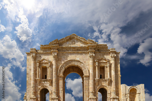 Arch of Hadrian in Gerasa (Jerash)-- was built to honor the visit of emperor Hadrian to Jerash in 129/130 AD, Jordan. Against the background of a beautiful sky with clouds #986304795