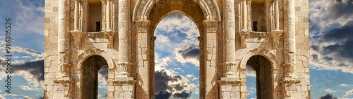 Arch of Hadrian in Gerasa (Jerash)-- was built to honor the visit of emperor Hadrian to Jerash in 129/130 AD, Jordan. Against the background of a beautiful sky with clouds #986305526