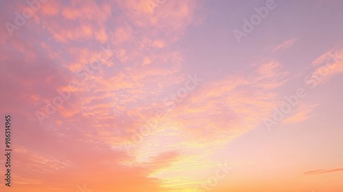 Colorful sunset sky with gentle orange and pink light reflecting off thin clouds