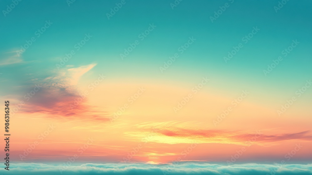 Fototapeta premium Gentle gradient of blue and peach in the sky as the sun rises