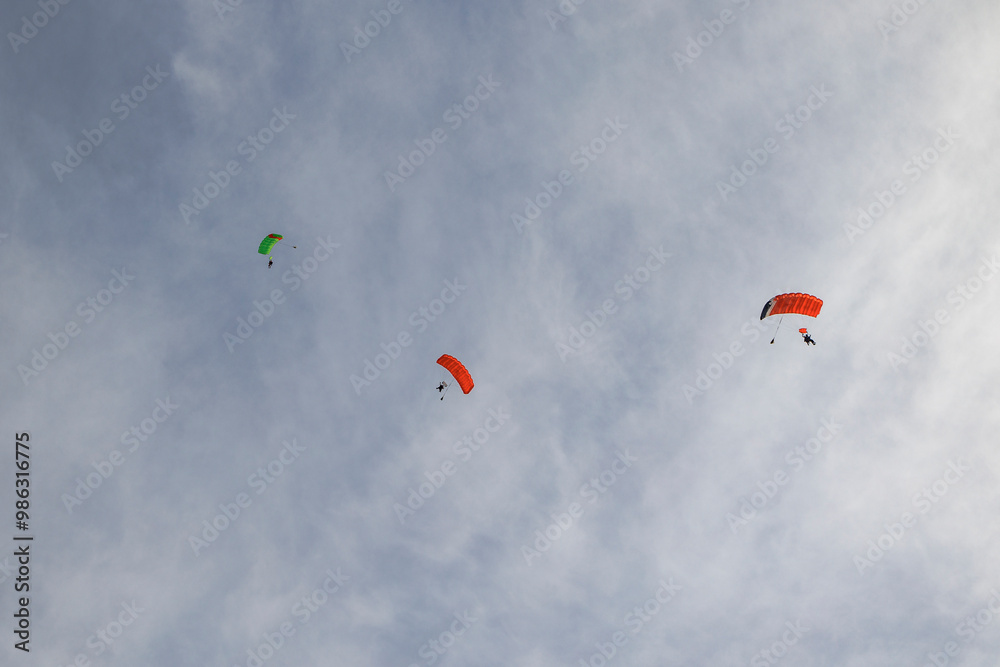 Tandem paraglider pilots with a slightly cloudy sky in Illertissen