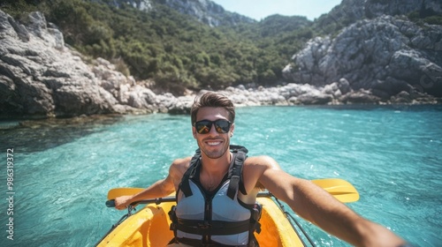 Portrait of a happy male in kayak boat exploring rocky valley in shallow sea photo