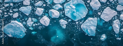 Wallpaper Mural An aerial view of an iceberg floating in the water, showcasing its massive size and intricate details. The cold blue tones of the ice contrast with the dark ocean waters. Torontodigital.ca