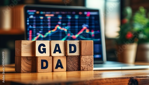 GDAX Highlighted on Wooden Block Next to a Laptop, Symbolizing Digital Currency and Business Innovation photo