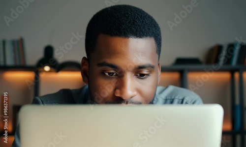 Tunisian Man Writing Online Purchase Review at Desk