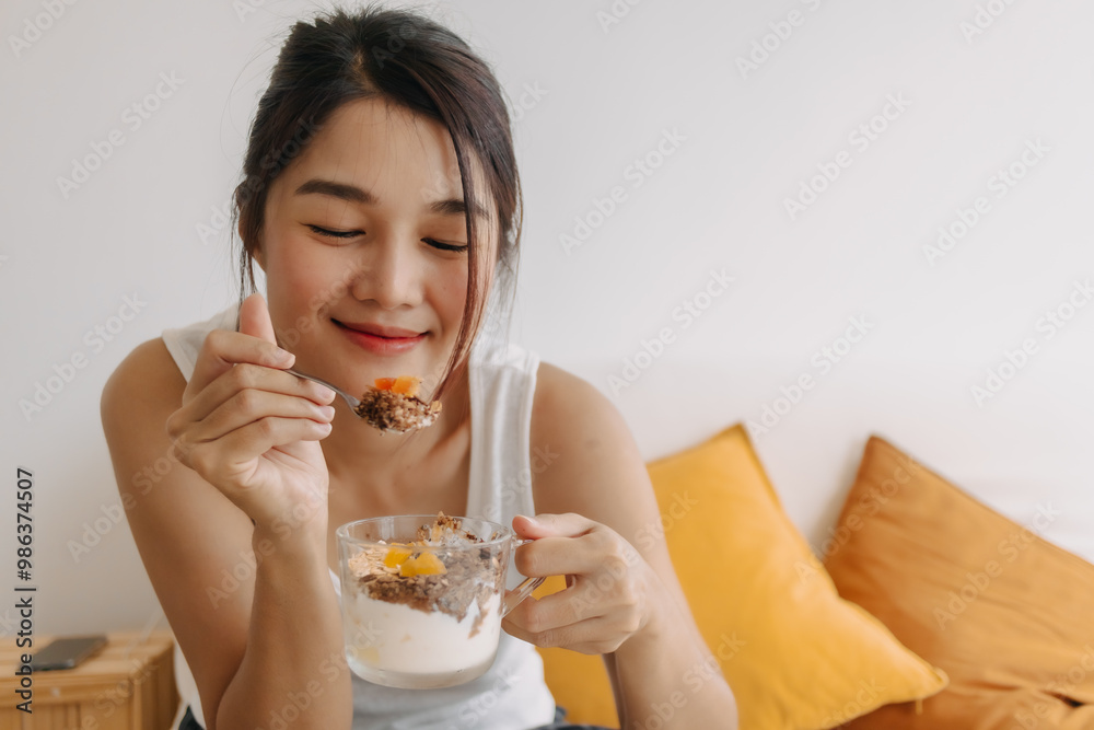Asian woman proud to present a cup of homemade yogurt snack for healthy diet. Asian woman proud to present a cup of homemade yogurt snack for healthy diet.