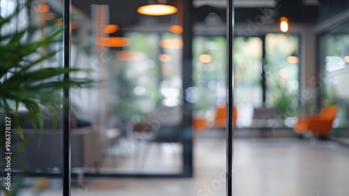 A bright, modern office interior featuring glass partitions, blurred background, soft lighting, and sleek contemporary furniture for a professional atmosphere.