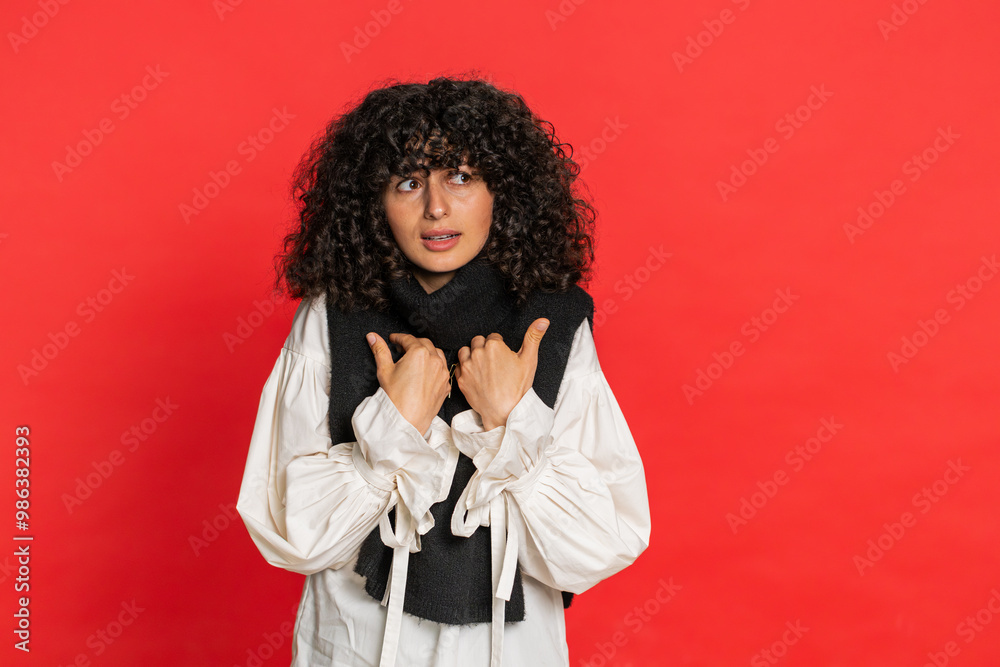 I am not guilty. Caucasian woman with curly hair pointing fingers herself ask say who me no thanks i do not need it, feels innocent, not her fault, fail mistake. Girl isolated on red background I am not guilty. Caucasian woman with curly hair pointing fingers herself ask say who me no thanks i do not need it, feels innocent, not her fault, fail mistake. Girl isolated on red background