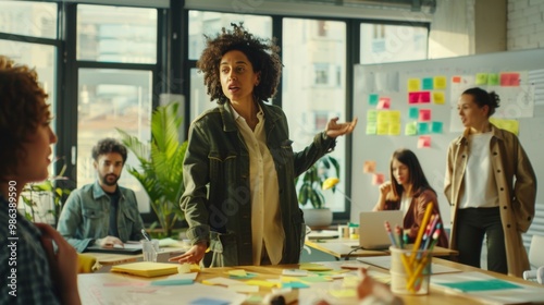 Female Business Coach for Company Management Explains How to Train your Team Efficiently in a Workshop Inside Creative Office. Woman Trainer Writing on Whiteboard and Training Interactive Employees