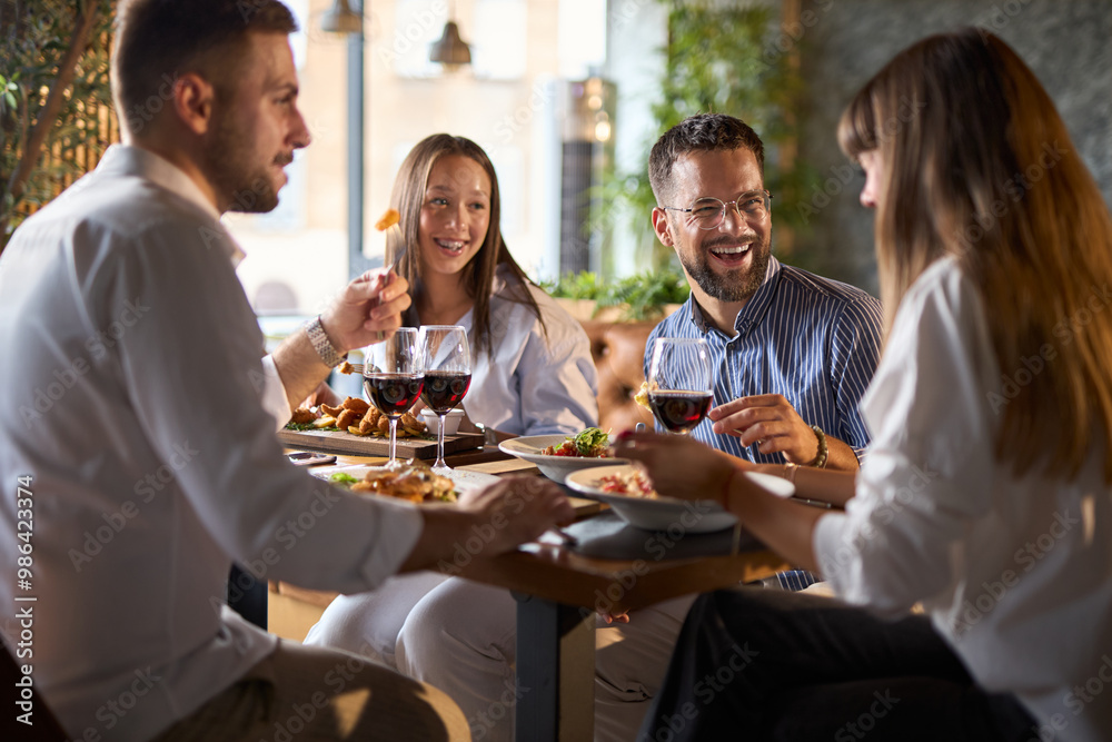 Happy business colleagues talking on a lunch in a restaurant. Happy business colleagues talking on a lunch in a restaurant.