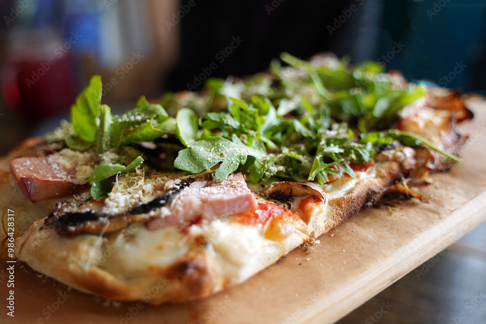 Traditional Italian pizza with arugula and tomatoes on a dark background. Traditional Italian pizza with arugula and tomatoes on a dark background.