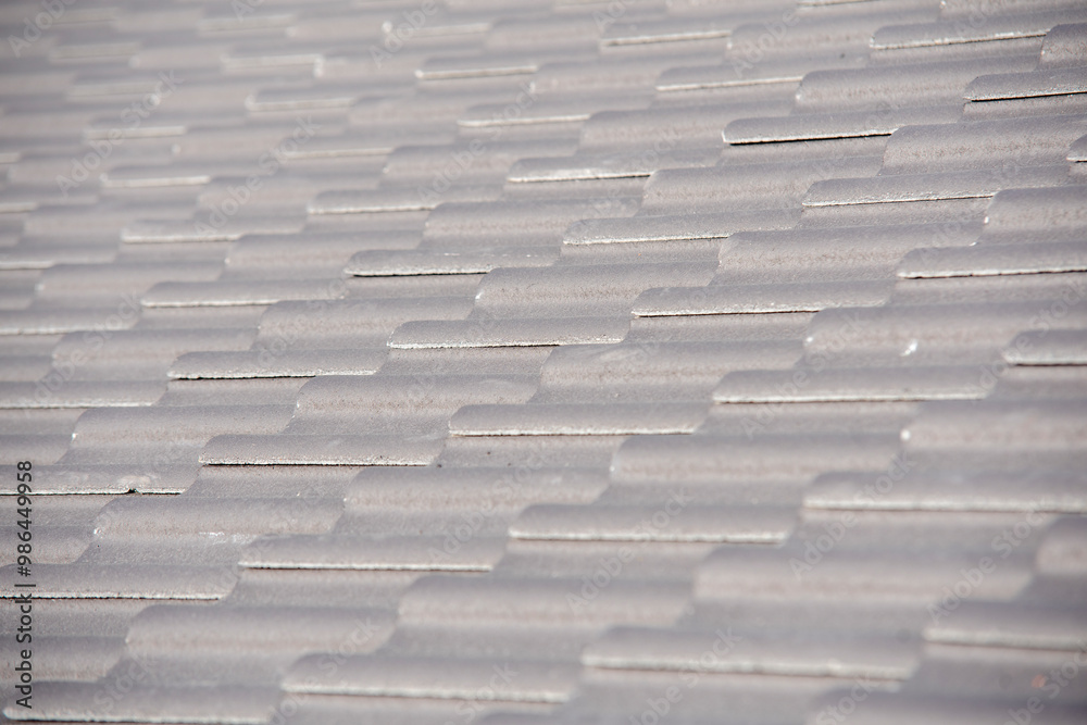 Fototapeta premium Textured Gray Slates Covering Rooftop of Residential Building at Midday