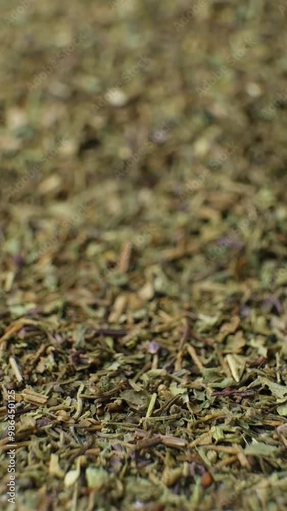 Dried basil spice sprinkles on white background slow motion vertical. Dried basil spice sprinkles on white background slow motion vertical.