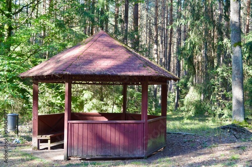 wooden gazebo for relaxing in the forest photo