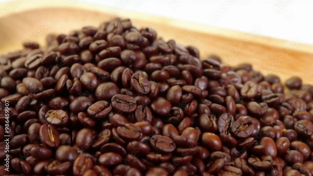 Whole coffee beans are sprinkled on a cutting board Whole coffee beans are sprinkled on a cutting board