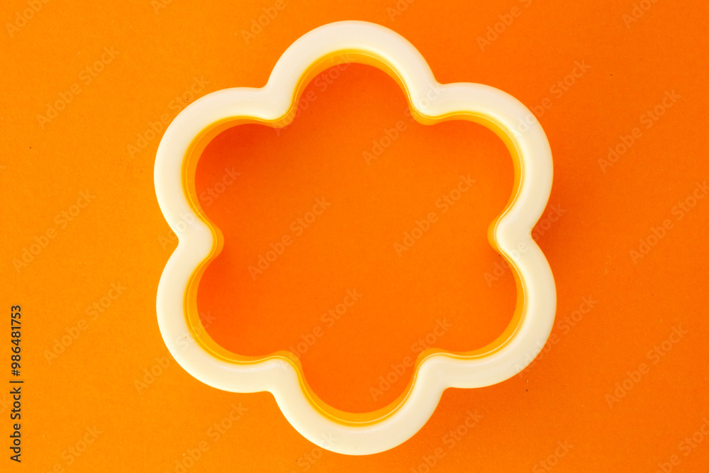 A cake mold made of plastic. This cake mold is used to mold the dough that will be made into a cake. The mold looks flower -shaped. A cake mold made of plastic. This cake mold is used to mold the dough that will be made into a cake. The mold looks flower -shaped.