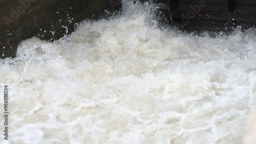 Beautiful View of water rushing Video. Indus River Head Taunsa Barrage Gates. View of water rushing through the gates at a dam. flowing and splashing water in cold river. Beautiful 4K Footage.	