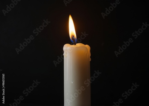 a white candle on a black background