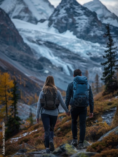 A couple hikes through a mountain landscape. AI.