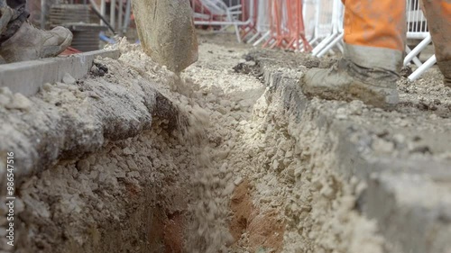 Digging Deep with Vacuum Excavator: Construction Workers Excavate Trench around live services for Urban Infrastructure Project photo