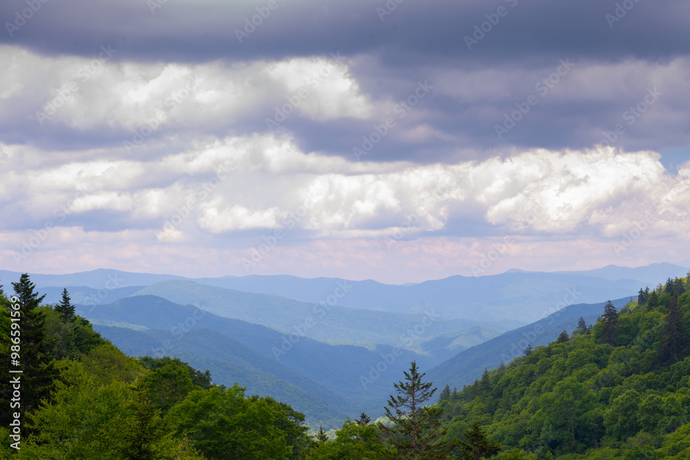 Cloudy skies hanging over a view of the Great Smoky Mountains stretching to the horizon Cloudy skies hanging over a view of the Great Smoky Mountains stretching to the horizon