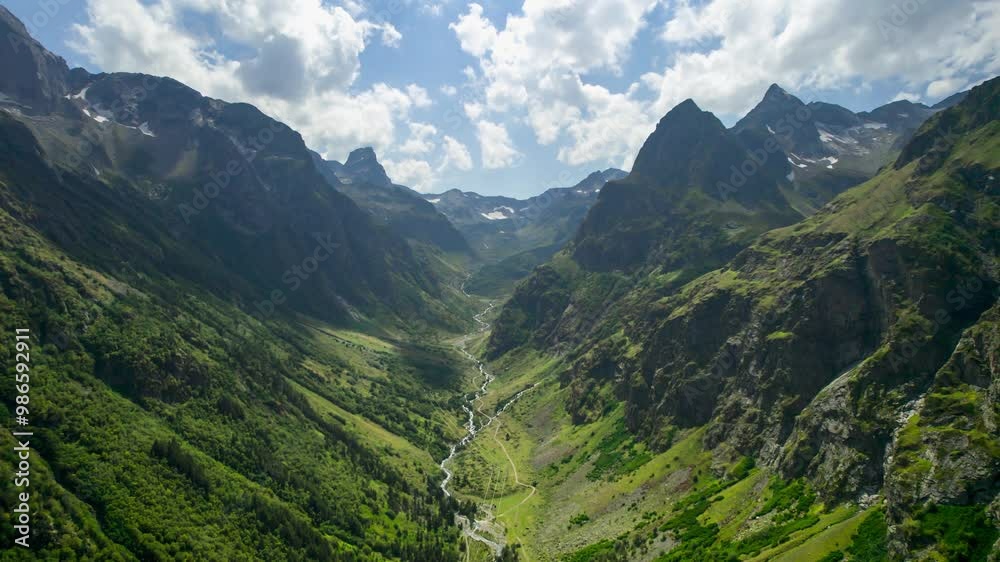 Beautiful aerial view of a mountain valley with picturesque peaks. Landscape and nature of the North Caucasus. Traveling around Russia Beautiful aerial view of a mountain valley with picturesque peaks. Landscape and nature of the North Caucasus. Traveling around Russia