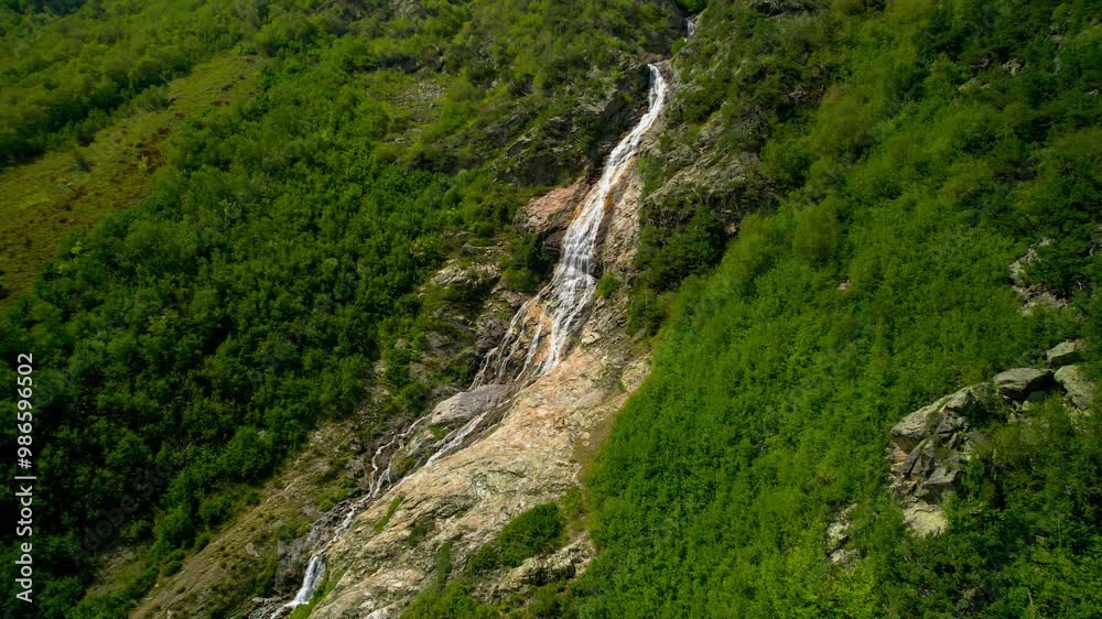 Beautiful view of a waterfall in a mountain gorge in the North Caucasus. Landscape and nature of the North Caucasus Beautiful view of a waterfall in a mountain gorge in the North Caucasus. Landscape and nature of the North Caucasus