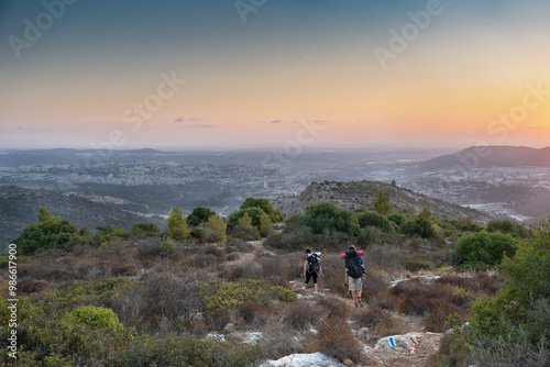 Israeli mountain landscape near Beit Shemesh town with couple of hikers in sunset photo