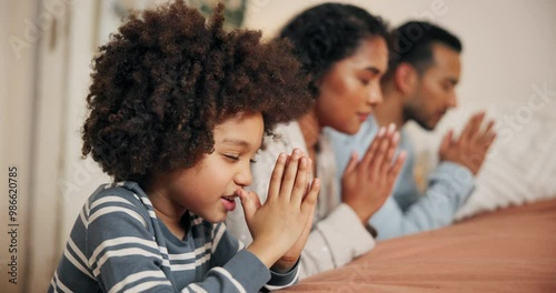 Family, pray and faith in bedroom at house for spiritual worship, gratitude and trust in God with religion respect. Child, parents and hands for holy praise, thankful belief and confession of people