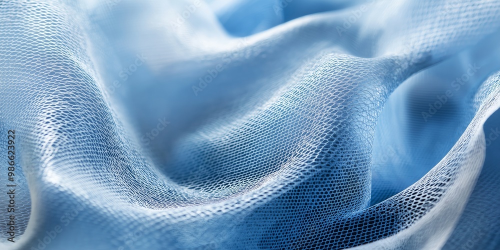 A blue fabric with a pattern of dots. The fabric is very soft and has a smooth texture A blue fabric with a pattern of dots. The fabric is very soft and has a smooth texture