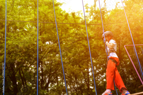 adventure climbing high wire park - people on course in mountain helmet