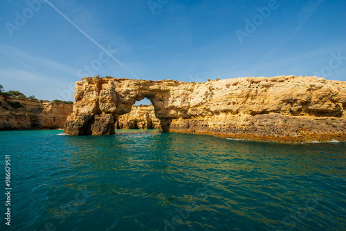 Rock formations and a natural arch on the stunning Algarve coastline, Portugal.