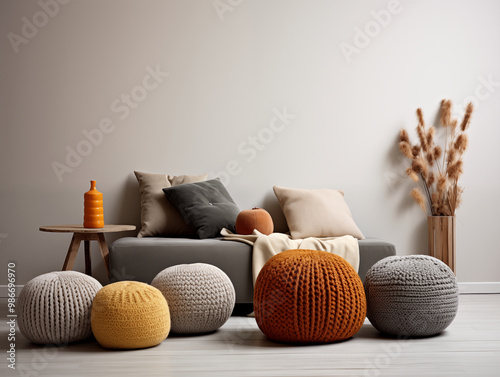 Modern interior design of scandinavian living room with chunky knit textured pouffs in autumn and neutral colors photo